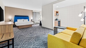 A hotel room with a bed, a desk, a yellow sofa, a kitchenette, and a bathroom. - Hampton Inn & Suites Tifton (Tifton)