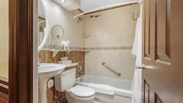 A bathroom with a toilet, sink, and bathtub.