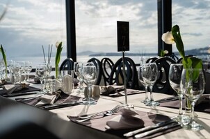 A table set for dining with a view of the sea, numbered 7, and simple tableware.