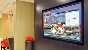 A GoBoard® display in a hotel lobby with a news ticker, a map, and a weather widget. - Courtyard by Marriott Knoxville Cedar Bluff (Knoxville)