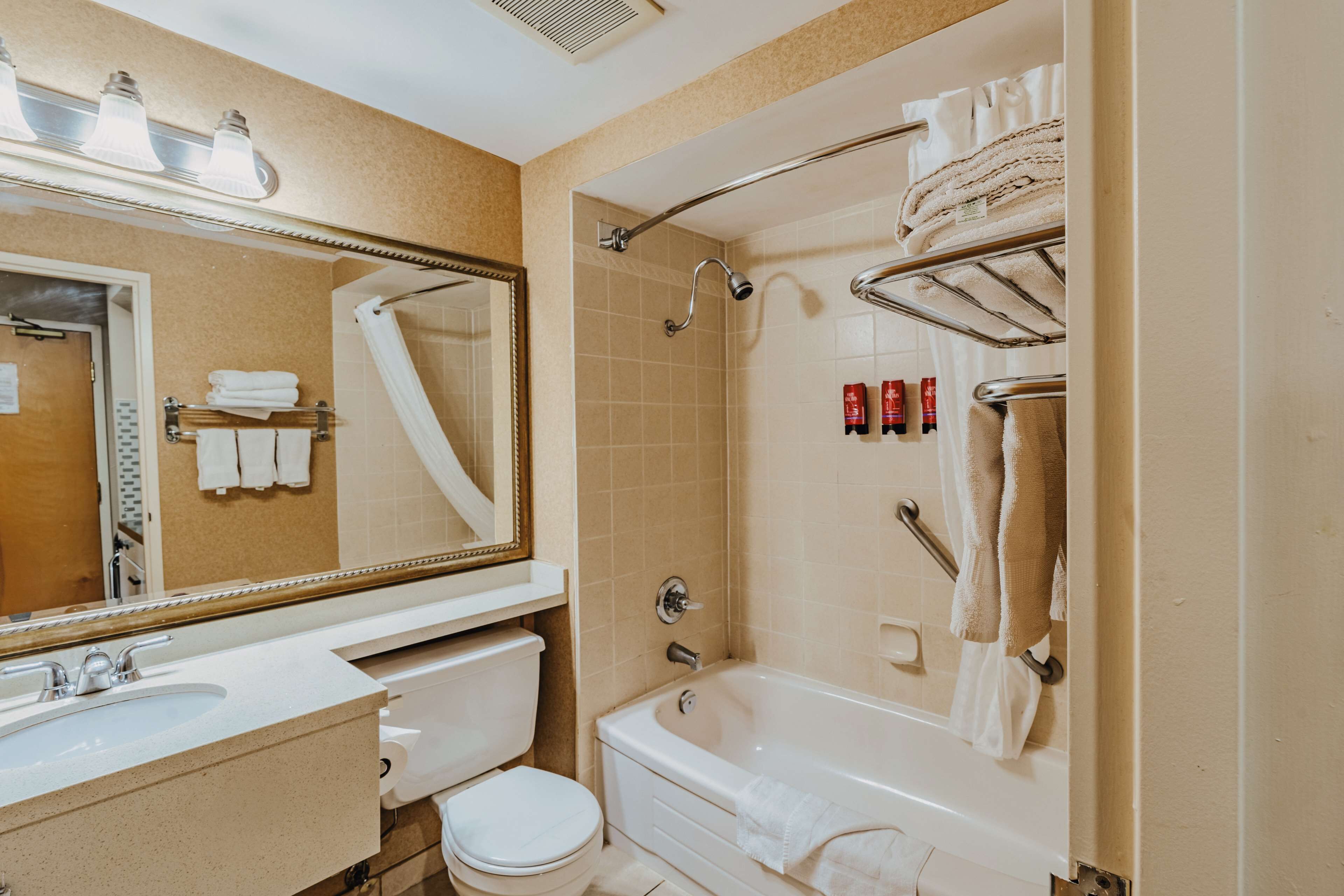 A bathroom with a sink, toilet, bathtub, and a shower.