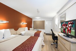 A hotel room with two beds, a desk, a television, and a mirror. - Red Roof Inn Parkersburg (Parkersburg)