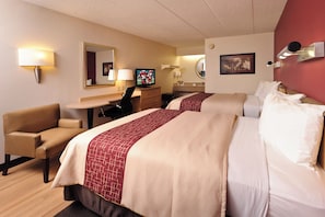 A hotel room with two beds, a desk, a chair, a television, and a bathroom. - Red Roof Inn Parkersburg (Parkersburg)