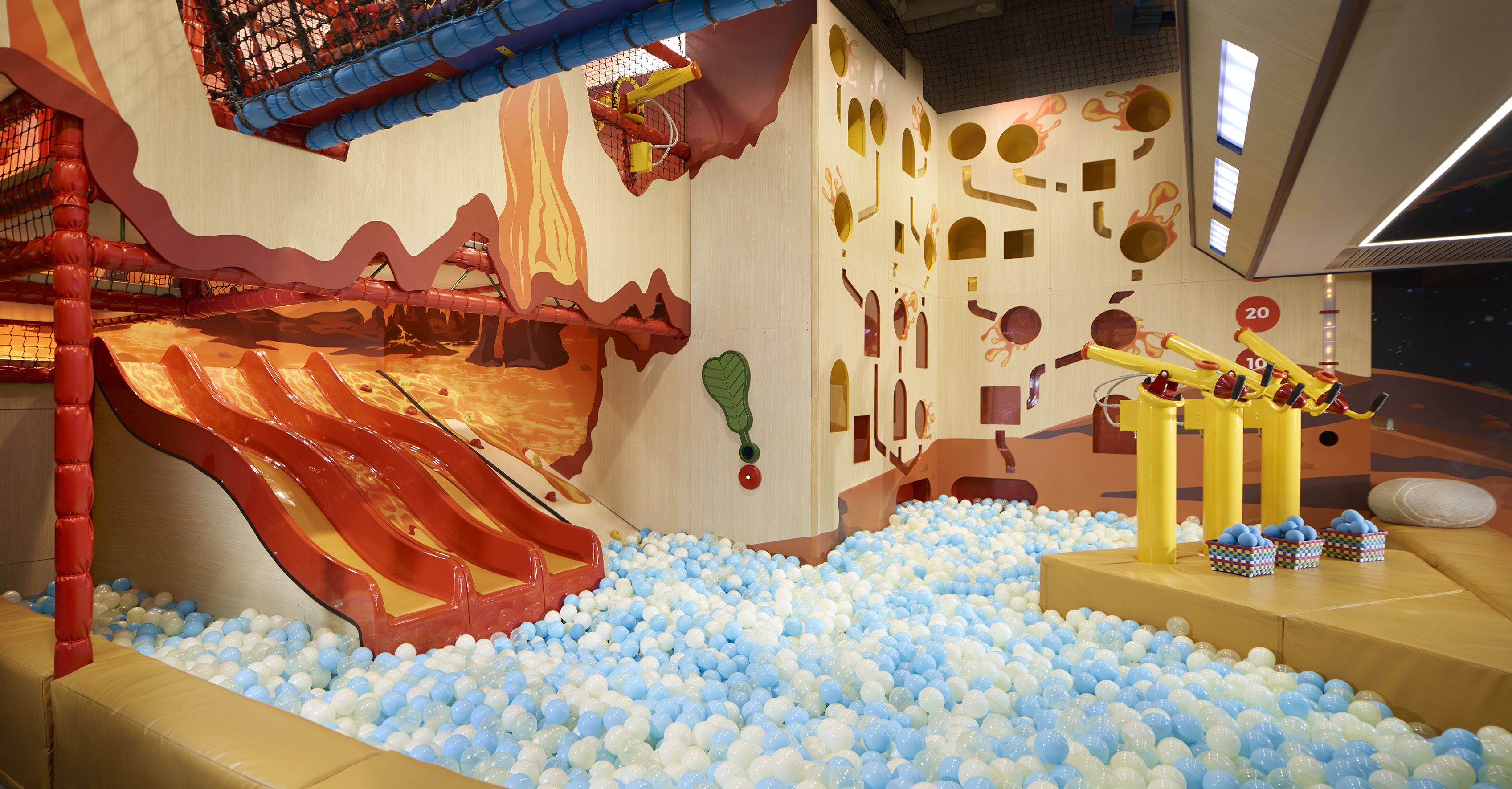 A play area with a slide, ball pit, and climbing structures.