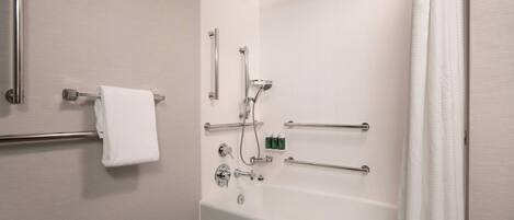A modern bathroom with a walk-in shower, grab bars, a towel rack, and a bathtub.