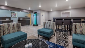 A hotel lobby with seating areas, a reception desk, and a restroom. - Best Western Deming Southwest Inn (Deming)