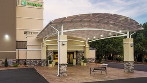 A Holiday Inn hotel entrance with a covered patio area and stone pillars. - Holiday Inn Boone - University Area by IHG (Boone)