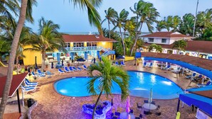 A resort with a swimming pool, lounge chairs, and palm trees. - Bimini Big Game Club Resort & Marina (Alice Town)