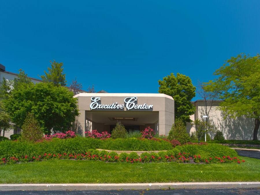 An Executive Center building with a landscaped garden in front.