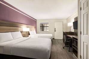 A hotel room with two beds, a desk with a chair, a TV, and a window. - La Quinta Inn by Wyndham San Antonio Lackland (San Antonio)