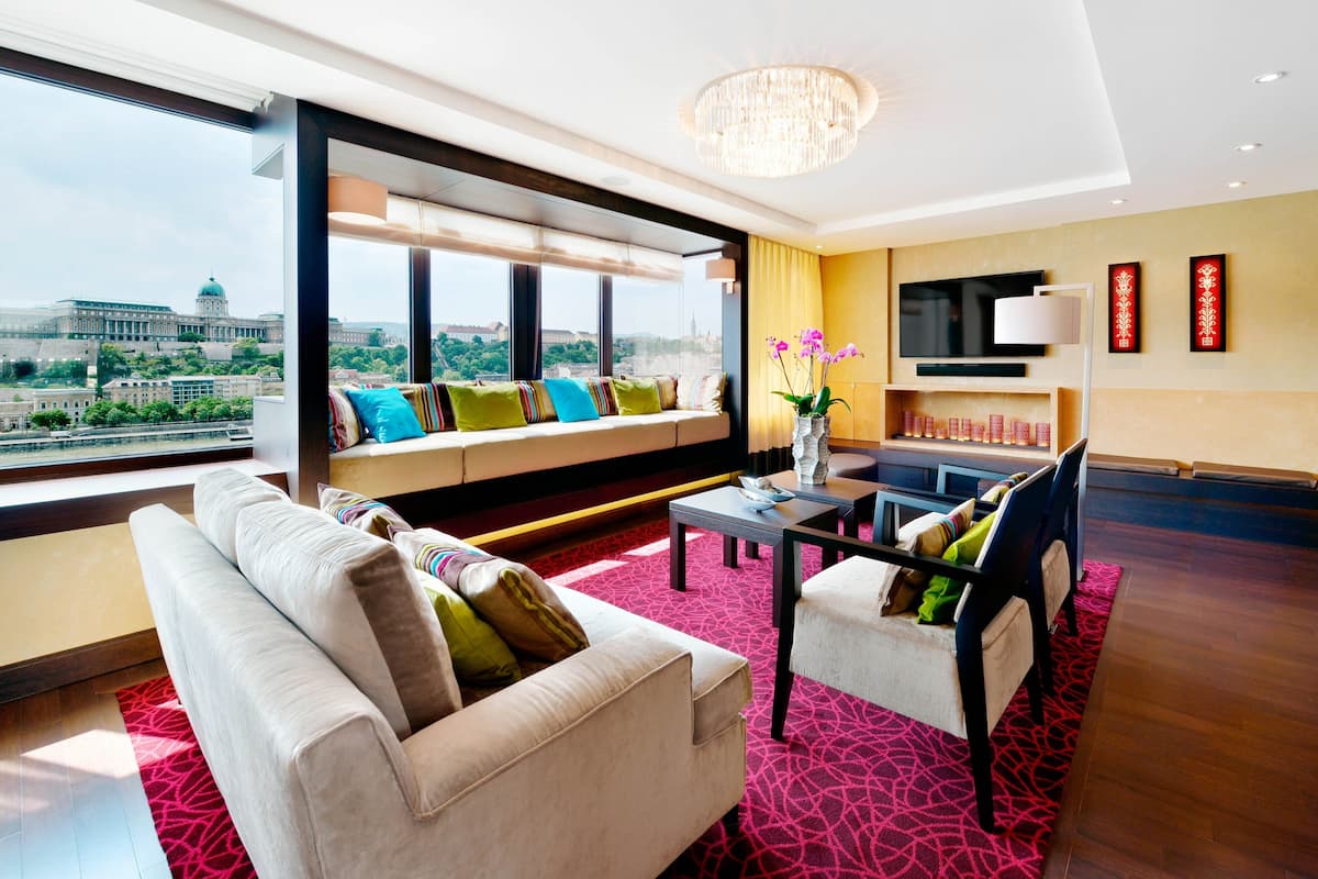 A modern living room with a sofa, a coffee table, and a TV.