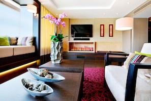 A modern living room with a sofa, coffee table, and decorative items.