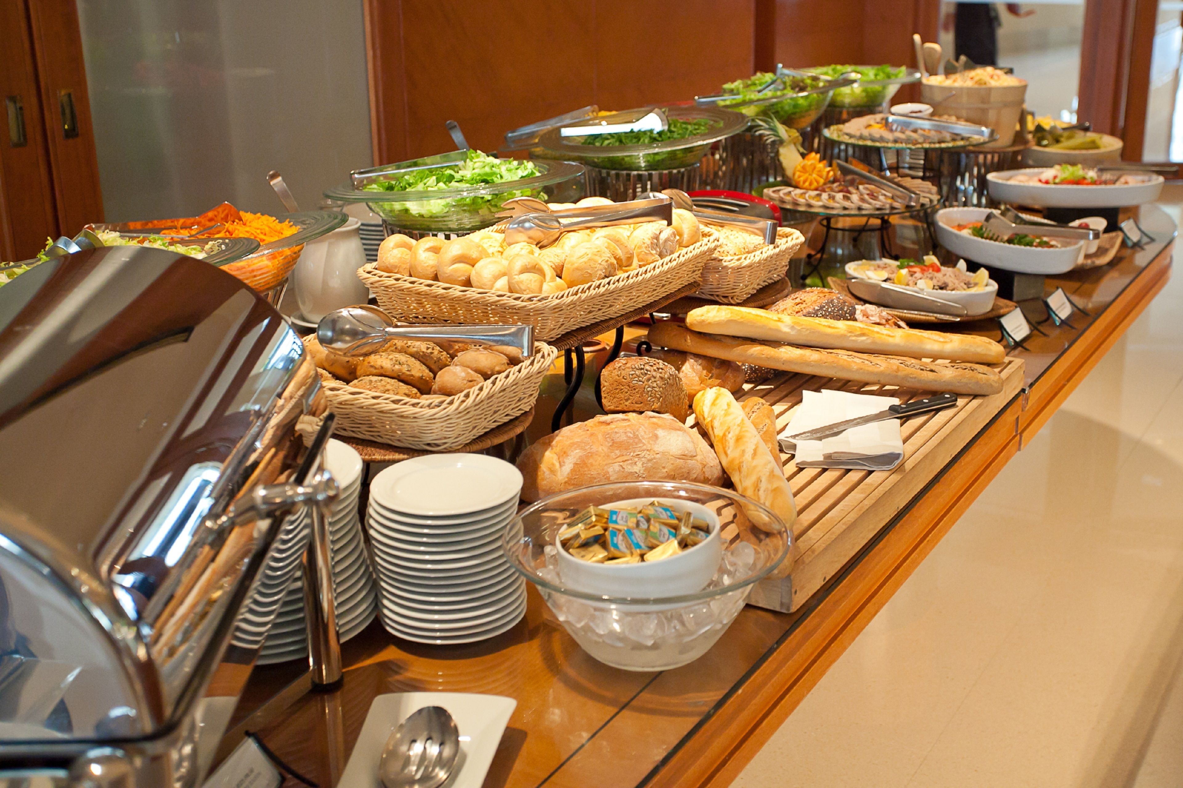 A buffet with various food items and serving utensils.