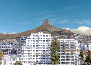 A hotel with multiple floors, balconies, and a view of a mountain. - Peninsula All-Suite Hotel by Dream Resorts (Cape Town)
