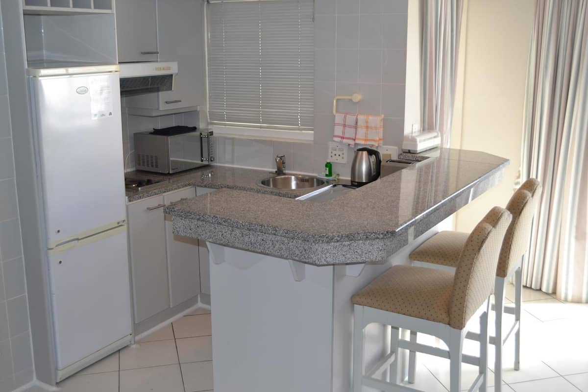 full-sized fridge, microwave, stovetop, dishwasher