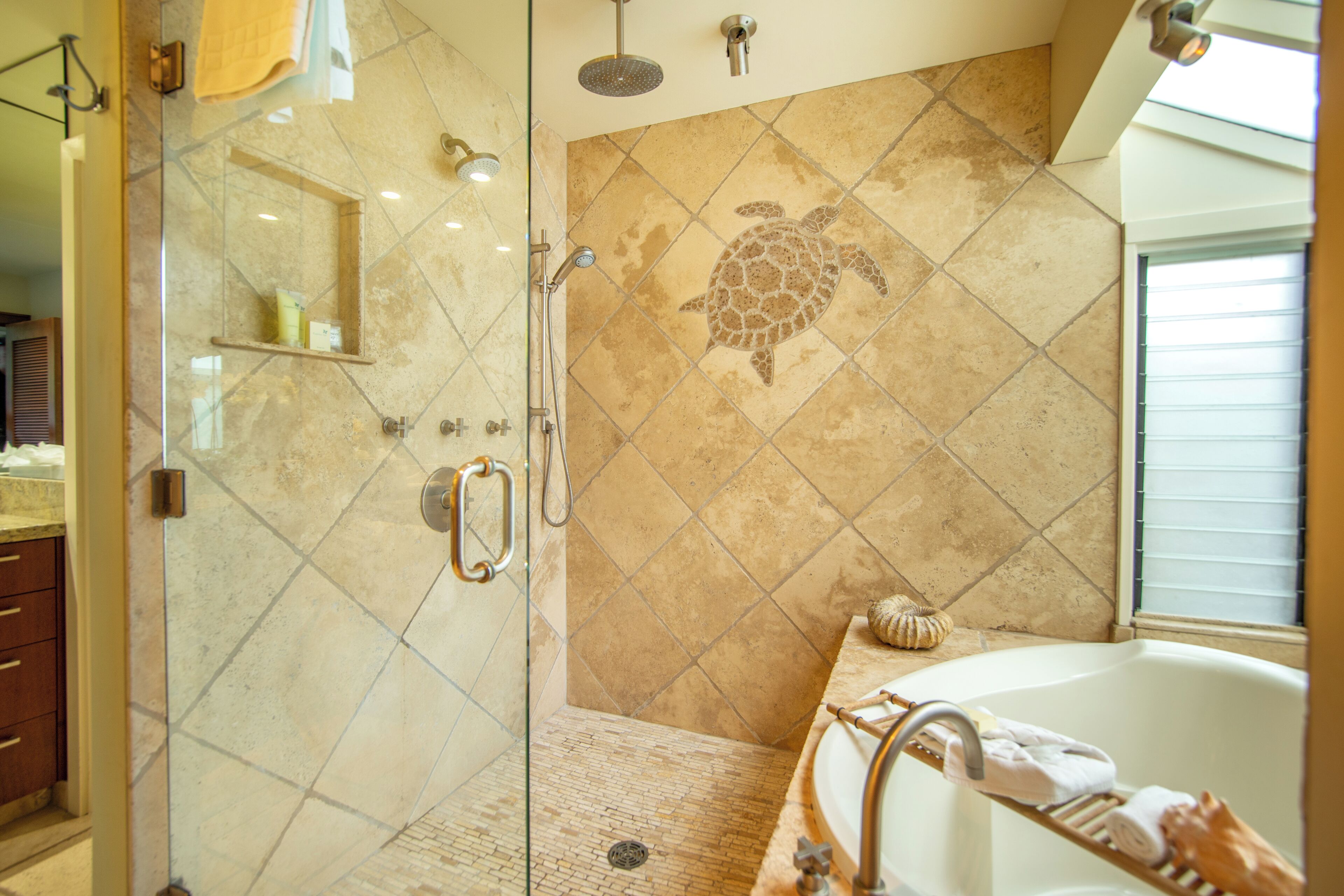A bathroom with a glass-enclosed shower, a bathtub, and a large mirror.