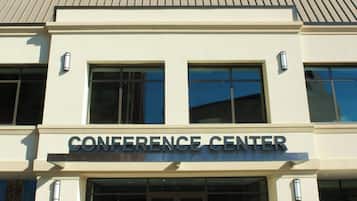 A building labeled "CONFERENCE CENTER" with a modern architectural style, large windows, and a clear entrance.