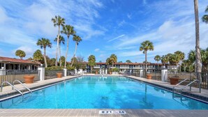 A swimming pool with a sign indicating a depth of 8 feet and a width of 24 feet. - Motel 6 Spring Hill, FL - Weeki Wachee (Spring Hill)
