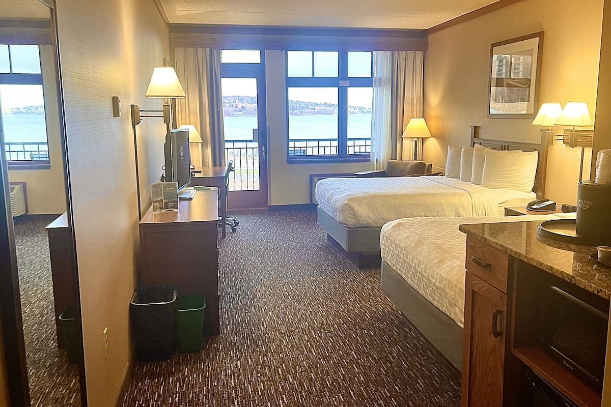 room, 2 queen beds, balcony, lake view | in-room safe, desk, iron/ironing board, free cots/infant beds