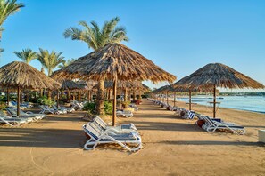 On the beach, sun-loungers, beach umbrellas, beach towels