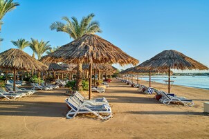 On the beach, sun loungers, beach umbrellas, beach towels