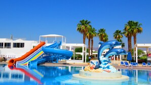 A swimming pool with a water slide and dolphin sculptures. - Maritim Jolie Ville Resort & Casino Sharm El Sheikh (Sharm El Sheikh)