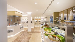 A modern buffet setup with various food stations and a clean, well-lit interior. - Hotel Son Caliu Spa Oasis (Calvia)