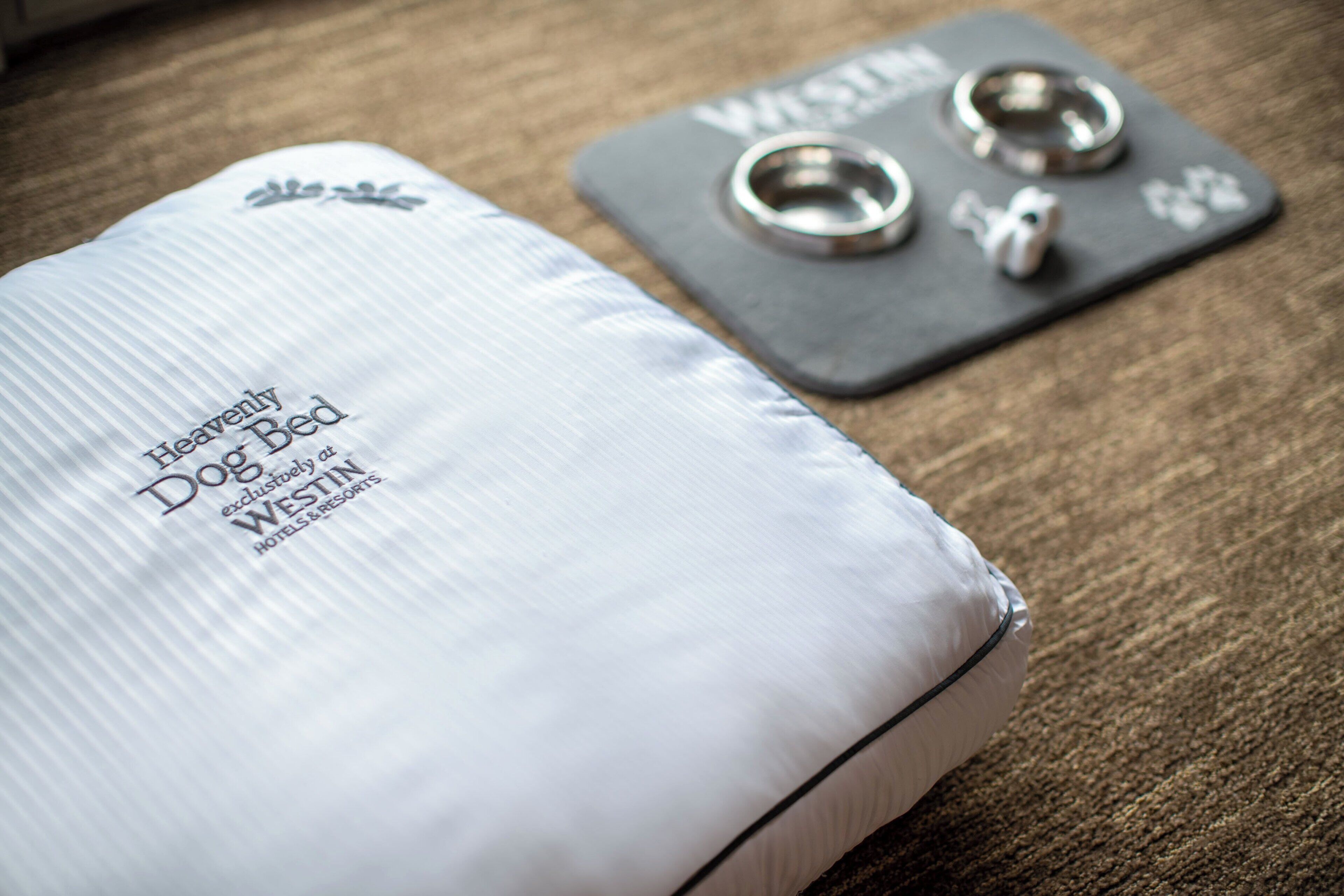 A white dog bed with the text "Heavenly Dog Bed" and "Westin Hotels & Resorts" on it.