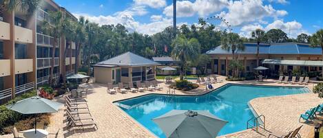 Relax by the resort's large pool surrounded by lounge chairs and umbrellas.