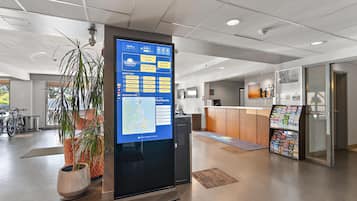 A digital kiosk with a map and information about hotel amenities and services.