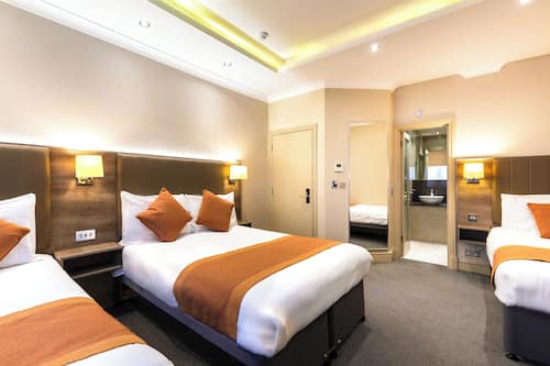 Standard Quadruple Room | In-room safe, desk, laptop workspace, blackout drapes