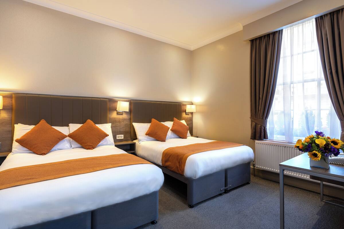 Standard Quadruple Room | In-room safe, desk, laptop workspace, blackout drapes