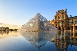 The Louvre Pyramid and the Louvre Museum's classical facade.