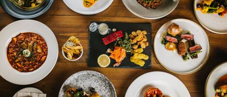 A variety of dishes arranged on a wooden table.