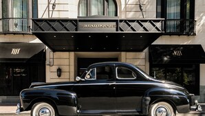 A classic black car parked in front of a building with a sign reading "The Read House." - The Read House Hotel (Chattanooga)
