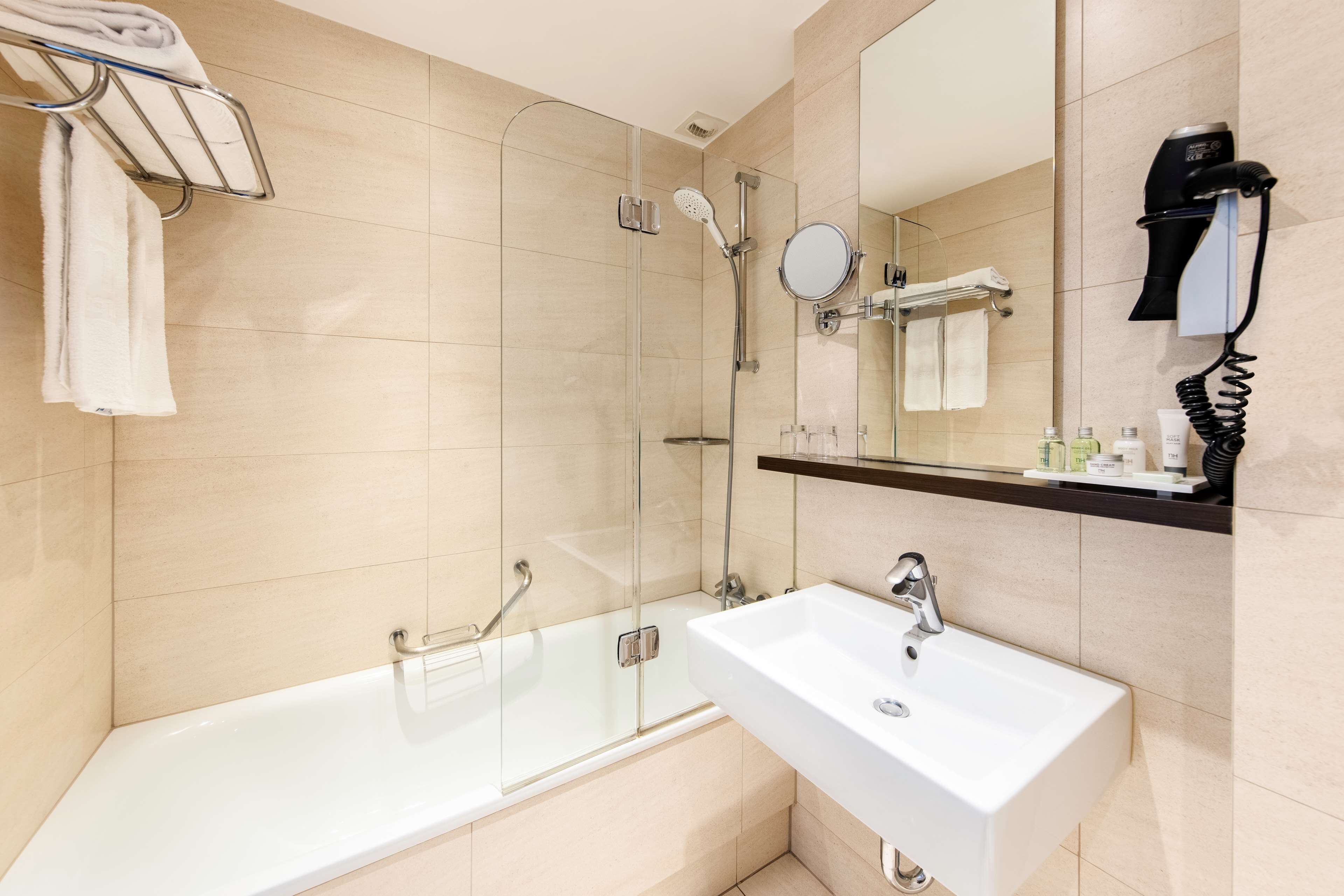 superior room | bathroom | bathtub, eco-friendly toiletries, hair dryer, towels