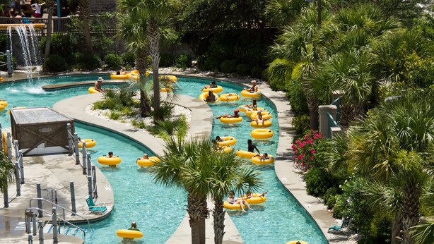 A water park with multiple swimming pools and people using inflatable tubes. - Sand Dunes Resort and Suites (Myrtle Beach)