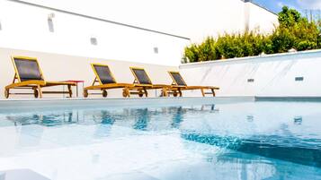 Seasonal outdoor pool, open 10:00 AM to 8:00 PM, pool umbrellas