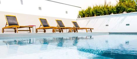 Seasonal outdoor pool, open 10:00 AM to 8:00 PM, pool umbrellas