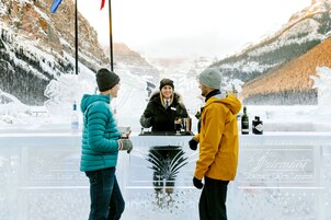 A clear glass barrier with a logo and text indicating a location in Chateau Lake Louise.