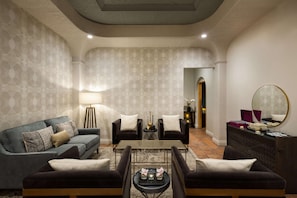 A modern living room with a sofa set, a coffee table, and a side table with decorative items.