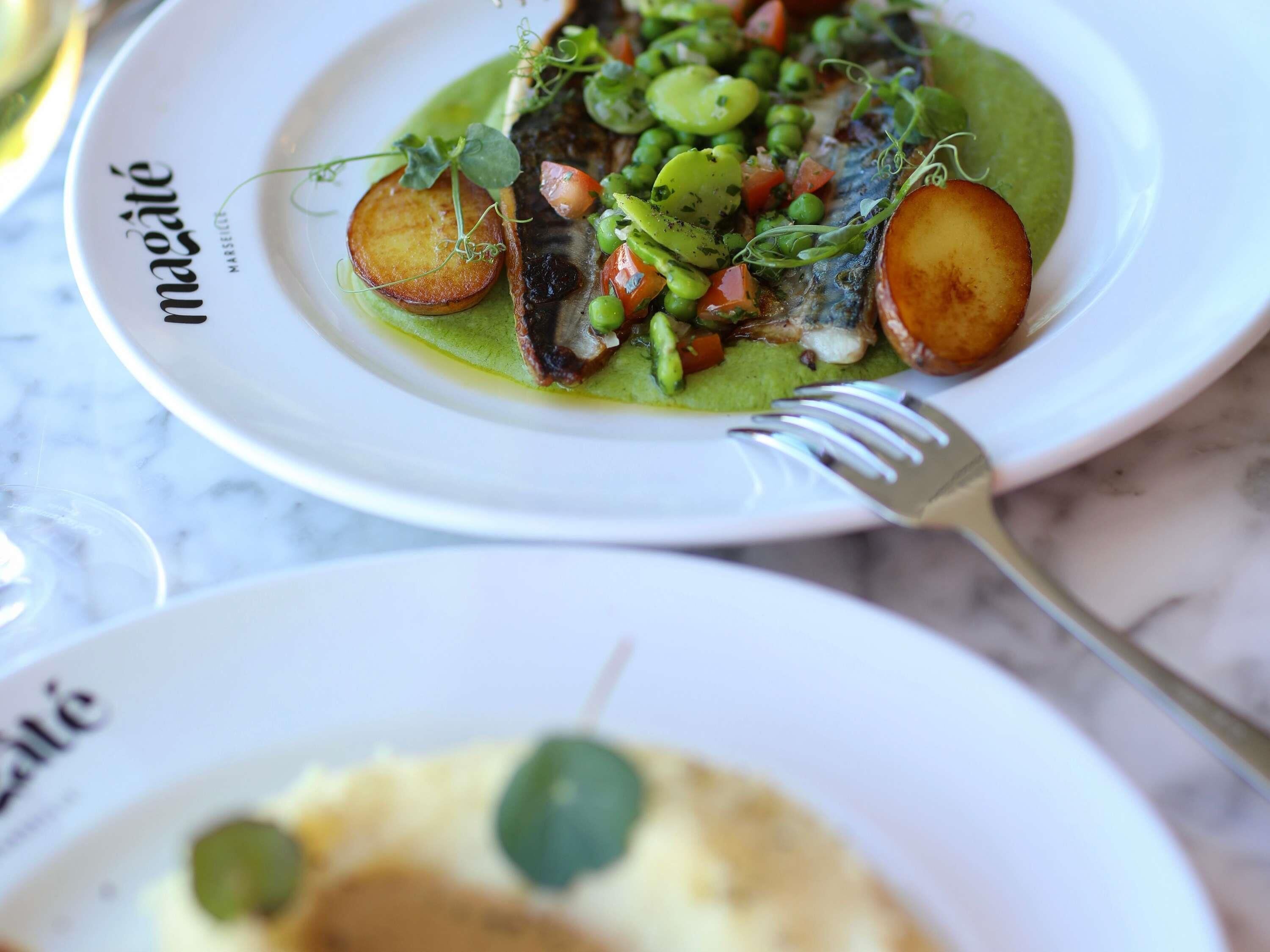 A plate of food with a fork on a table.