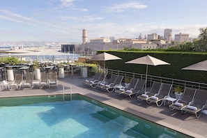 Seasonal outdoor pool, open 8:00 AM to 8:00 PM, pool umbrellas