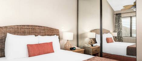 A hotel room with a large bed, two bedside tables with lamps, a mirror, and a view of the outside.