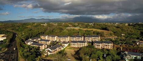 A residential area with multiple apartment buildings, roads, and surrounding greenery.