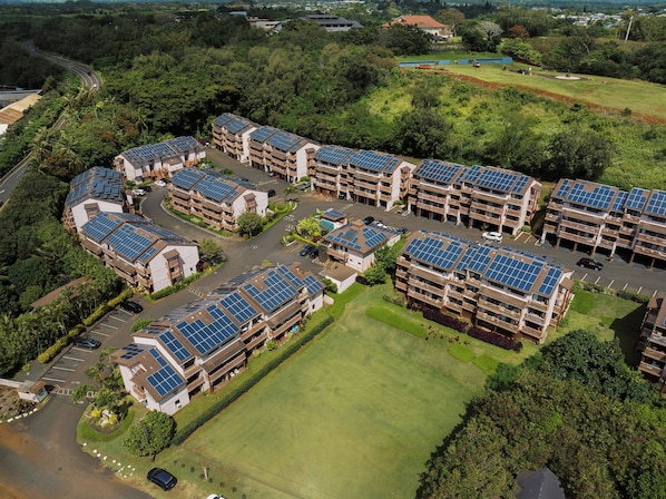 A residential complex with multiple buildings, each featuring solar panels on the roofs. - Banyan Harbor Resort (Lihue)