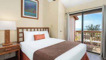 A hotel room with a bed, a nightstand, a lamp, a painting, and a balcony with a view.