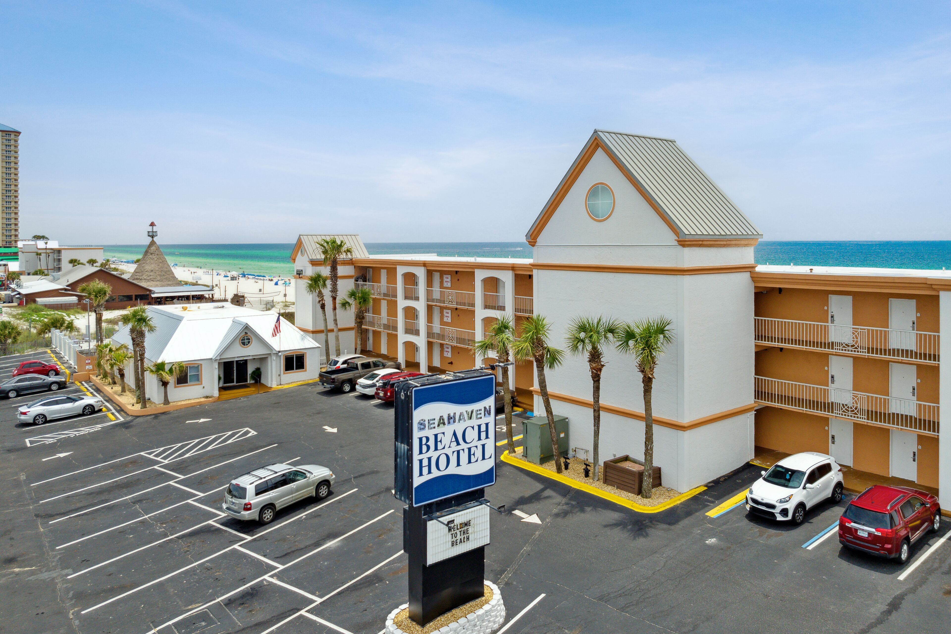 A beach hotel with a sign indicating it is the Seahaven Beach Hotel.