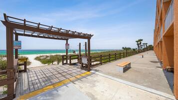 On the beach, white sand, sun loungers, beach volleyball