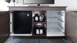 A compact minibar with a refrigerator, coffee maker, and beverage dispensers. - Hampton Inn St. Louis-Downtown (At the Gateway Arch) (St. Louis)